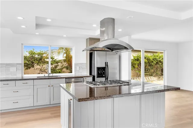 a kitchen with a sink and a large window