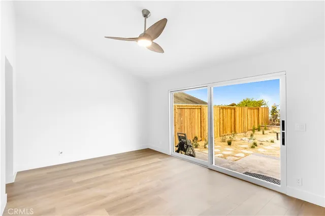 a view of a room with wooden floor and windows