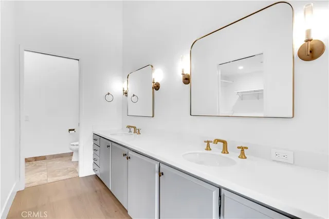 a spacious bathroom with a sink and a mirror