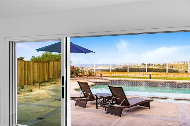 a view of a swimming pool and outdoor seating