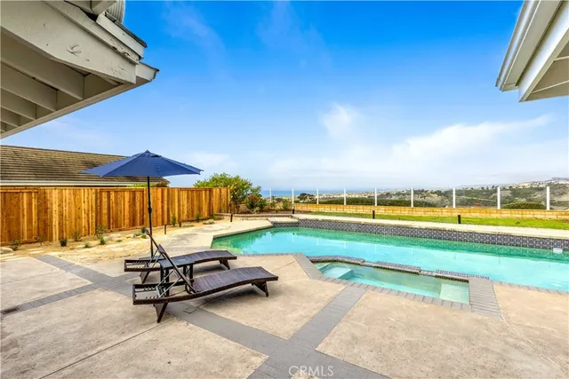 a view of swimming pool with outdoor seating and a yard
