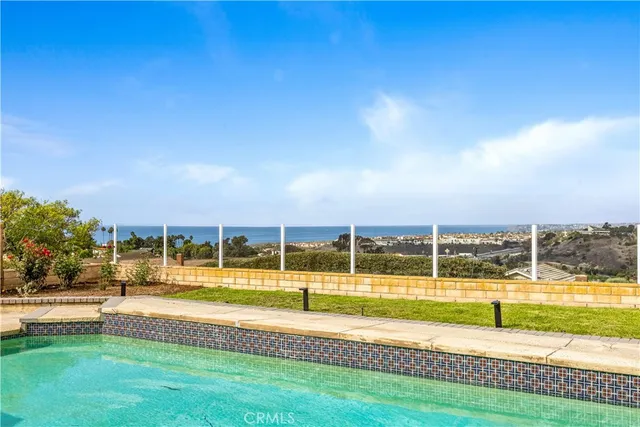 a view of a swimming pool with a lawn chairs and swimming pool