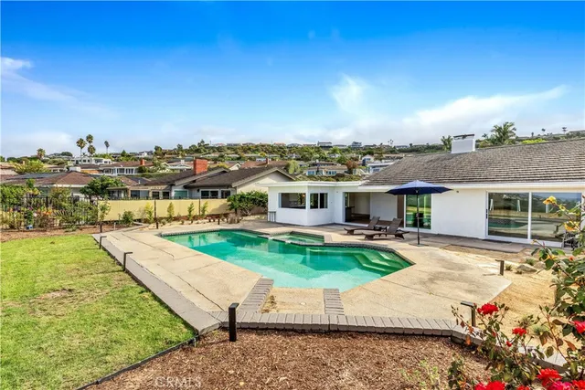 an aerial view of a house with swimming pool garden and patio