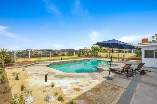 a view of a swimming pool with lounge chairs