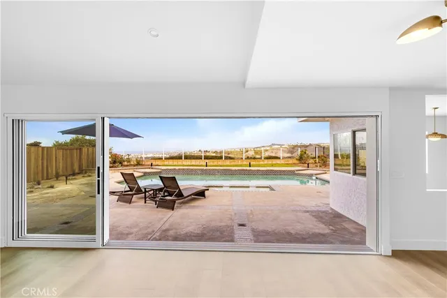 a view of a living room and floor to ceiling window