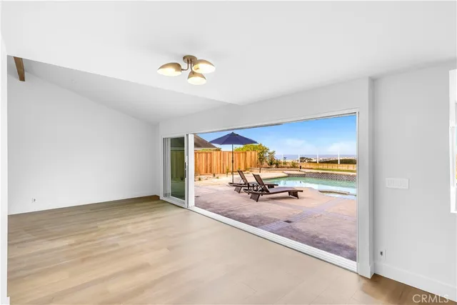 an empty room with furniture and natural light