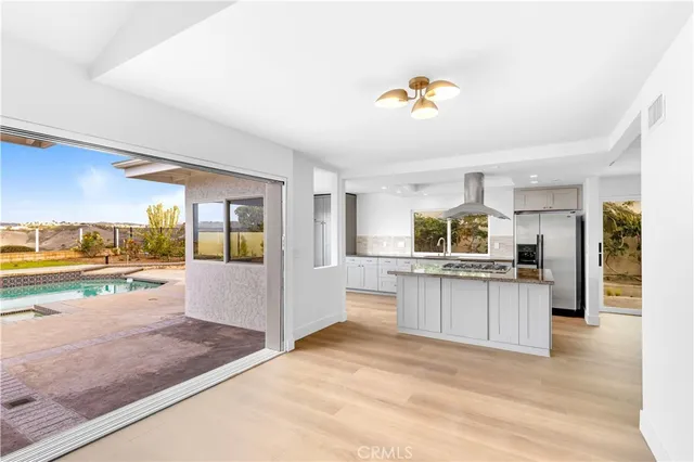 a kitchen with stainless steel appliances granite countertop a stove and cabinets