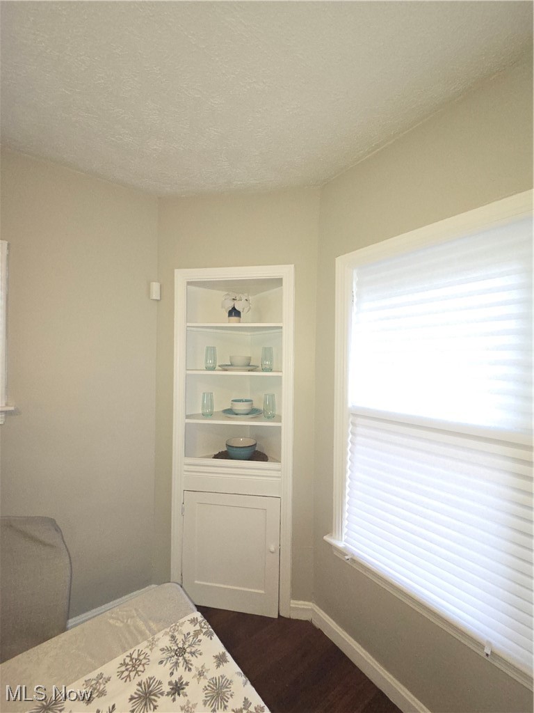 3797 Delmore Road Cleveland, OH 44121 - Photo 10 of 39 Bedroom with dark wood-style flooring and a textured ceiling