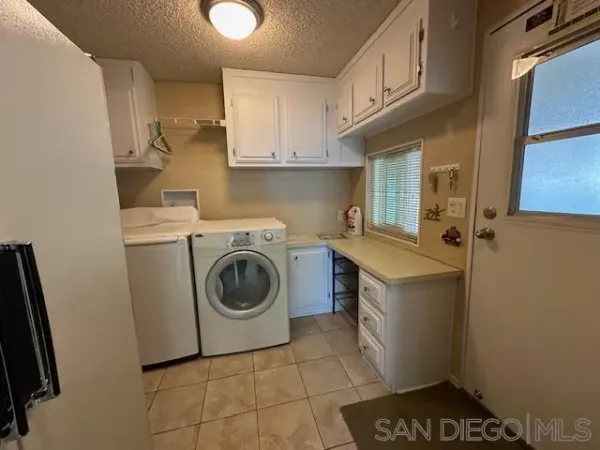 a utility room with sink dryer and washer