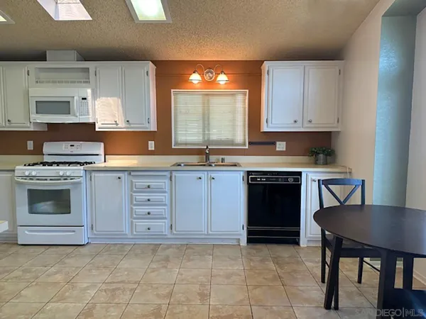 a kitchen with a stove a sink and a refrigerator