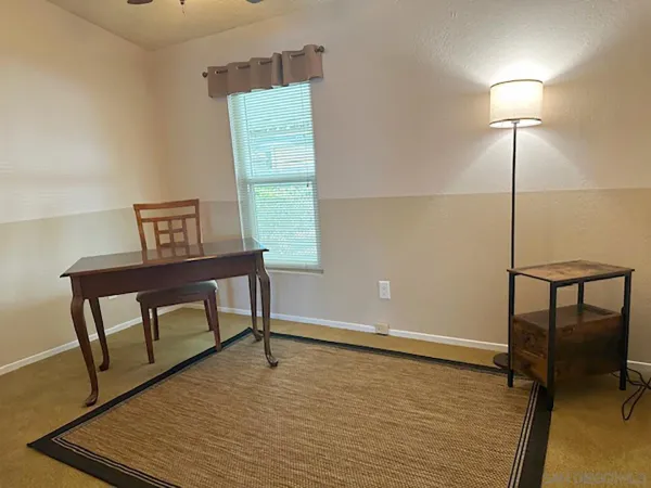 a view of a room with a window and wooden floor