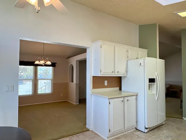 a kitchen with refrigerator and window