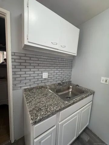a view of kitchen island sink and refrigerator