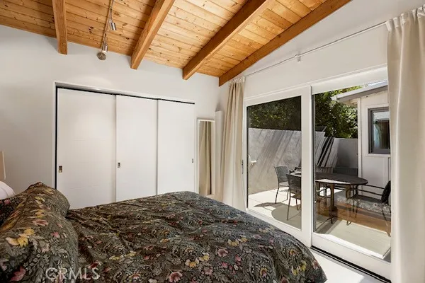 a bedroom with a bed and a flat tv screen