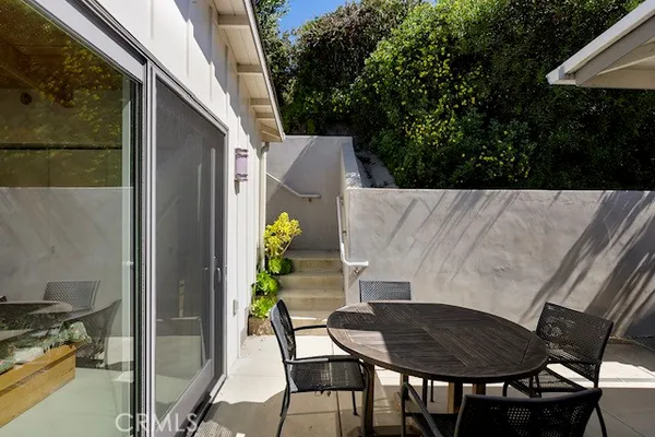 a backyard of a house with table and chairs