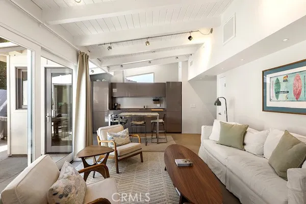 a living room with furniture wooden floor and a flat screen tv