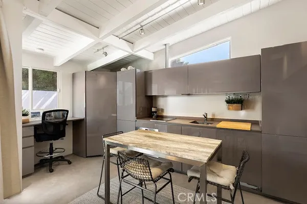 a kitchen with a table chairs stove and refrigerator