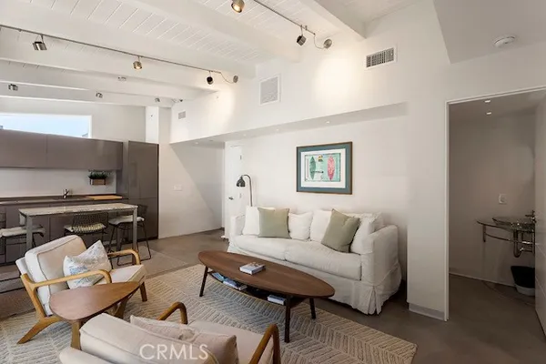 a living room with furniture a rug and a painting on the wall