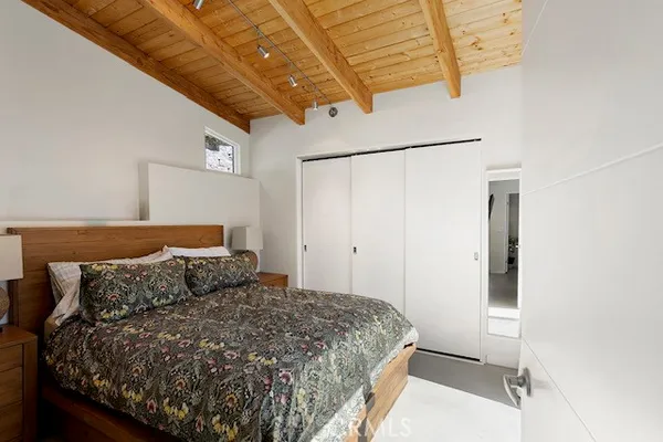 a bedroom with a bed and a dresser