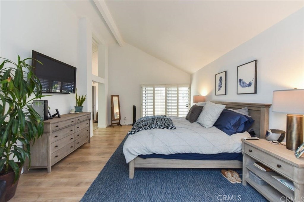 17 Elderberry Irvine, CA 92603 - Photo 13 of 24 a spacious bedroom with a bed and a flat screen tv