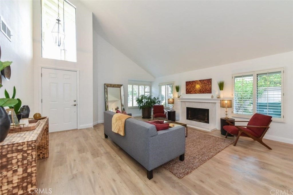 17 Elderberry Irvine, CA 92603 - Photo 4 of 24 a living room with furniture a fireplace and a potted plant