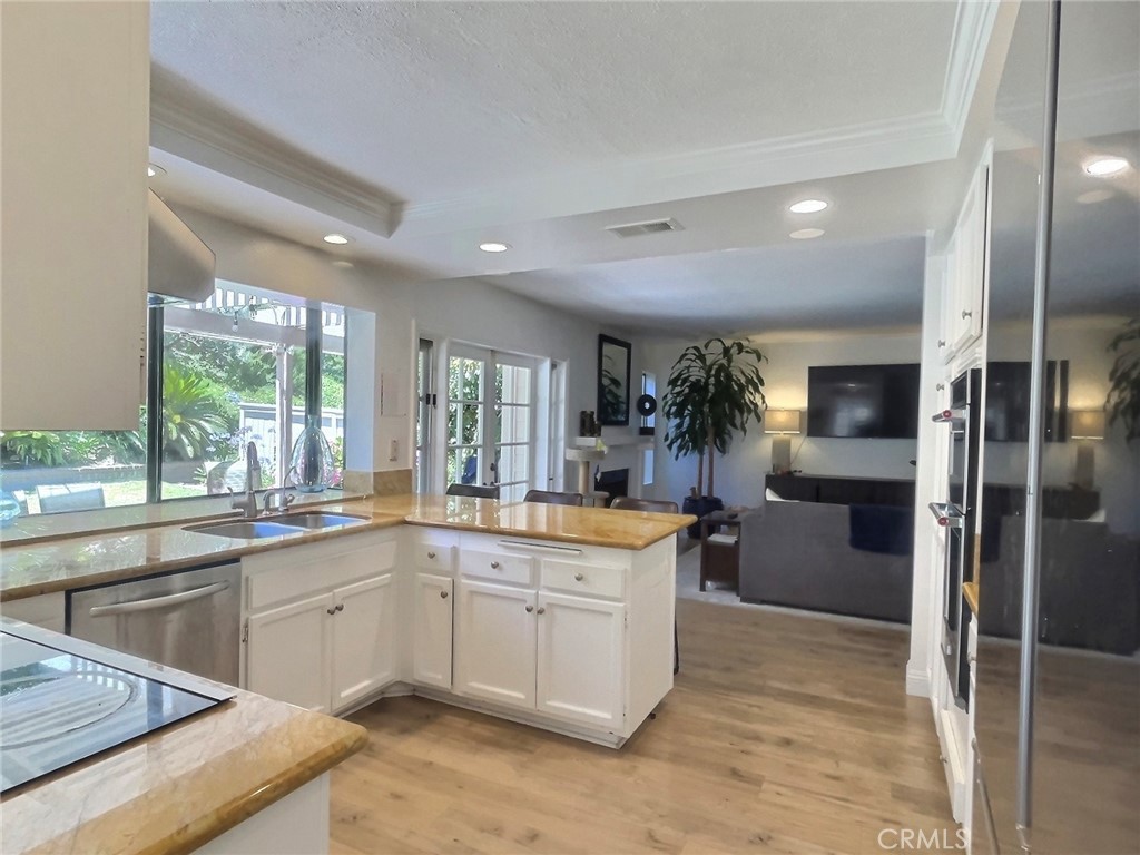 17 Elderberry Irvine, CA 92603 - Photo 7 of 24 a kitchen with a sink stove and refrigerator
