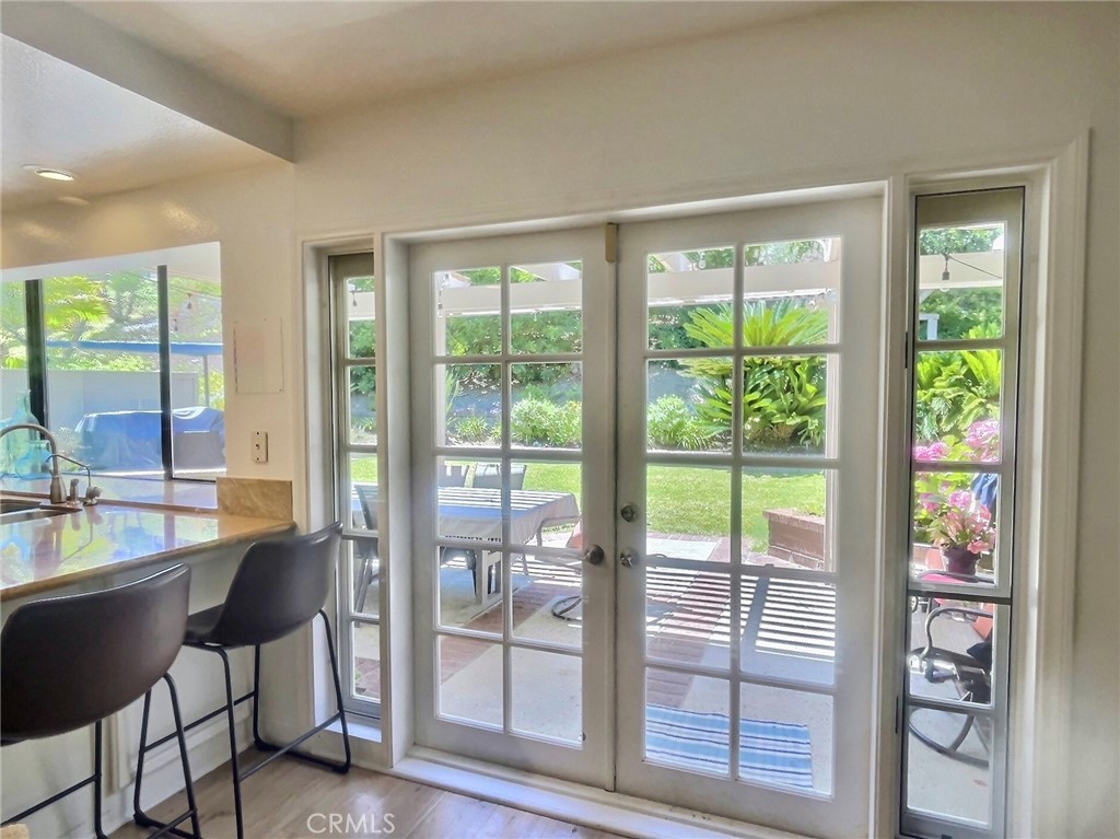 17 Elderberry Irvine, CA 92603 - Photo 9 of 24 a dining room with wooden floor and glass windows