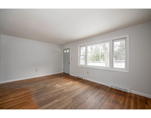 316 Andover Road Billerica, MA 01821 - Photo 8 of 16 a view of an empty room with wooden floor and a window
