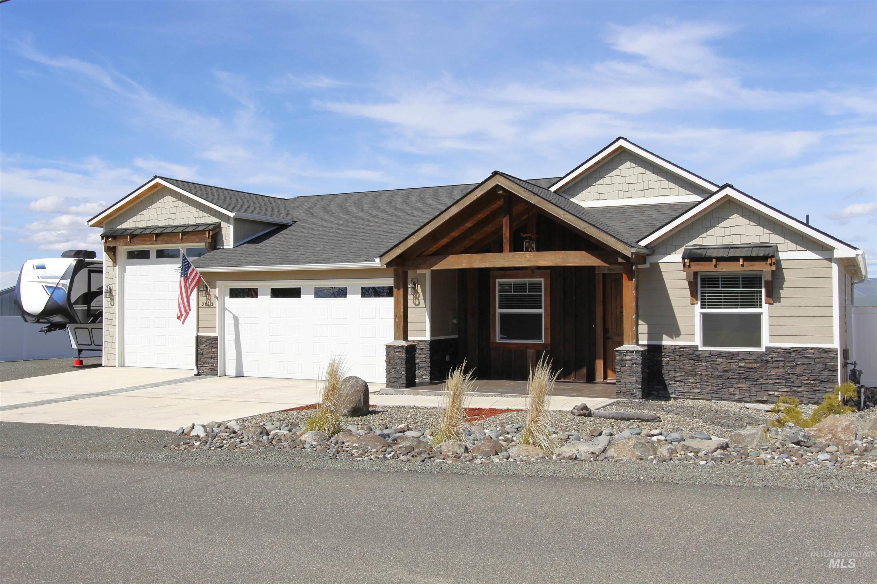 Craftsman inspired home featuring stone siding, an attached garage, a porch, concrete driveway, and a shingled roof