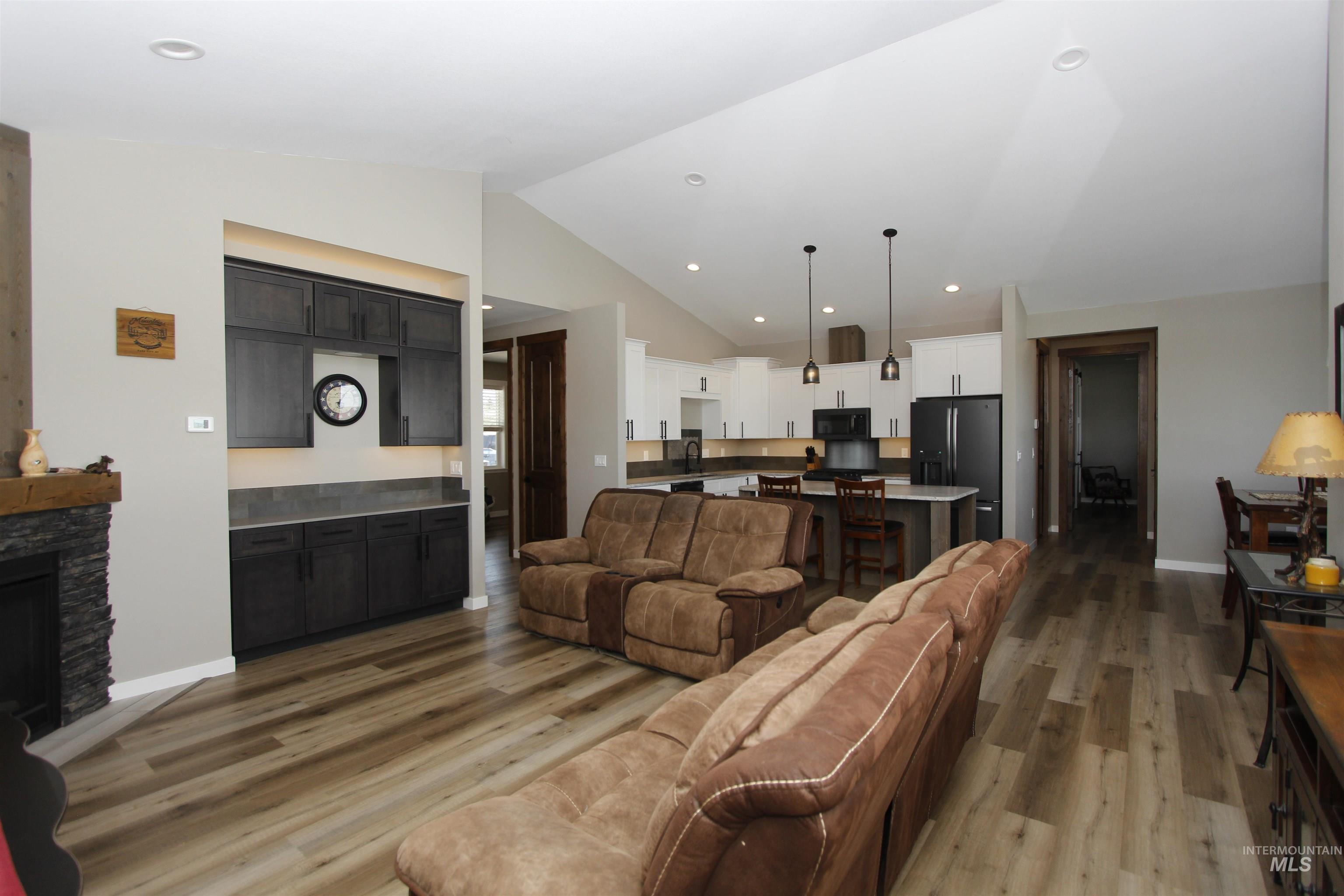 2013 Cedar Avenue Lewiston, ID 83501 - Photo 14 of 46 Living room featuring vaulted ceiling, light wood-style floors, recessed lighting, and a stone fireplace