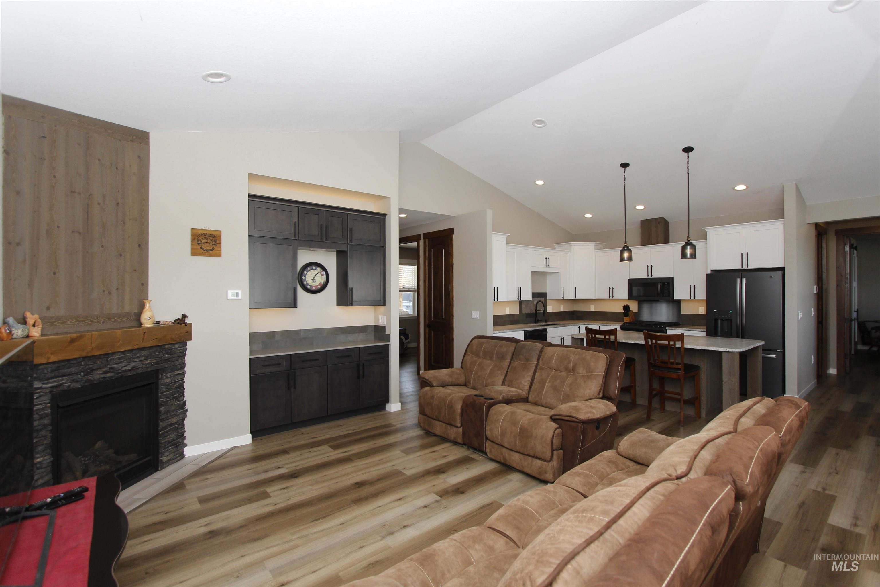 2013 Cedar Avenue Lewiston, ID 83501 - Photo 15 of 46 Living room with vaulted ceiling, wood finished floors, a fireplace, and recessed lighting