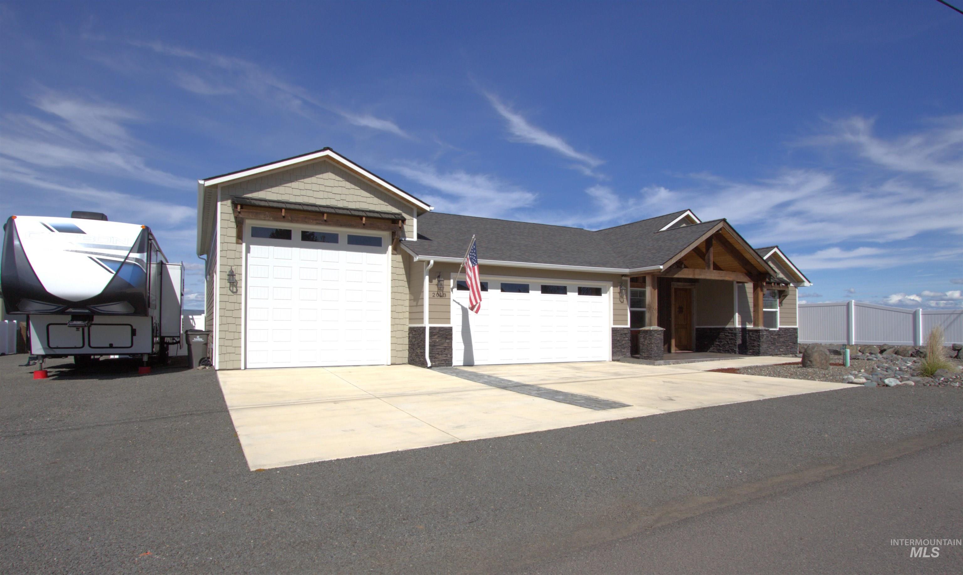 2013 Cedar Avenue Lewiston, ID 83501 - Photo 2 of 46 View of front of property featuring stone siding, an attached garage, and concrete driveway