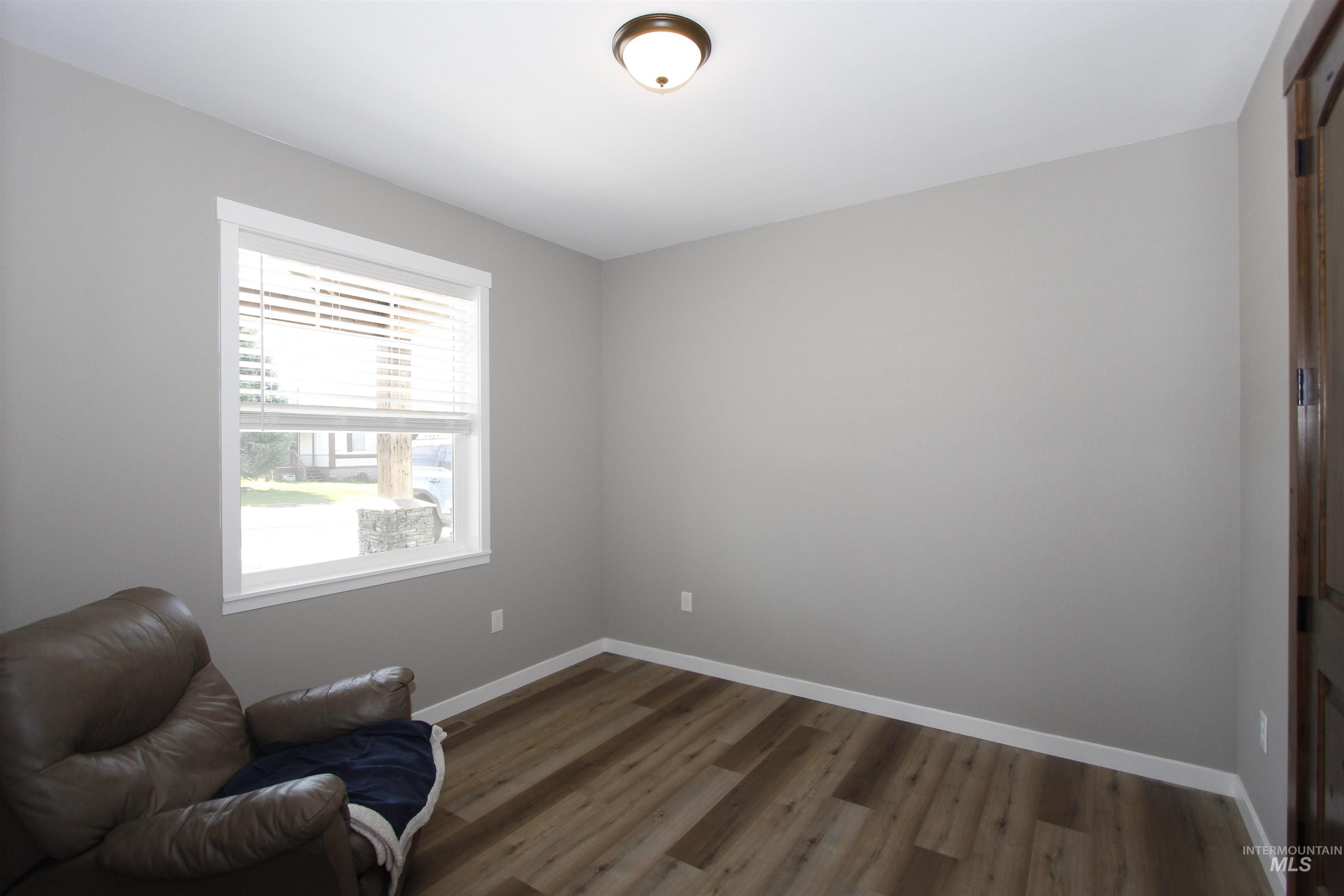 2013 Cedar Avenue Lewiston, ID 83501 - Photo 25 of 46 Living area with baseboards and dark wood-style flooring