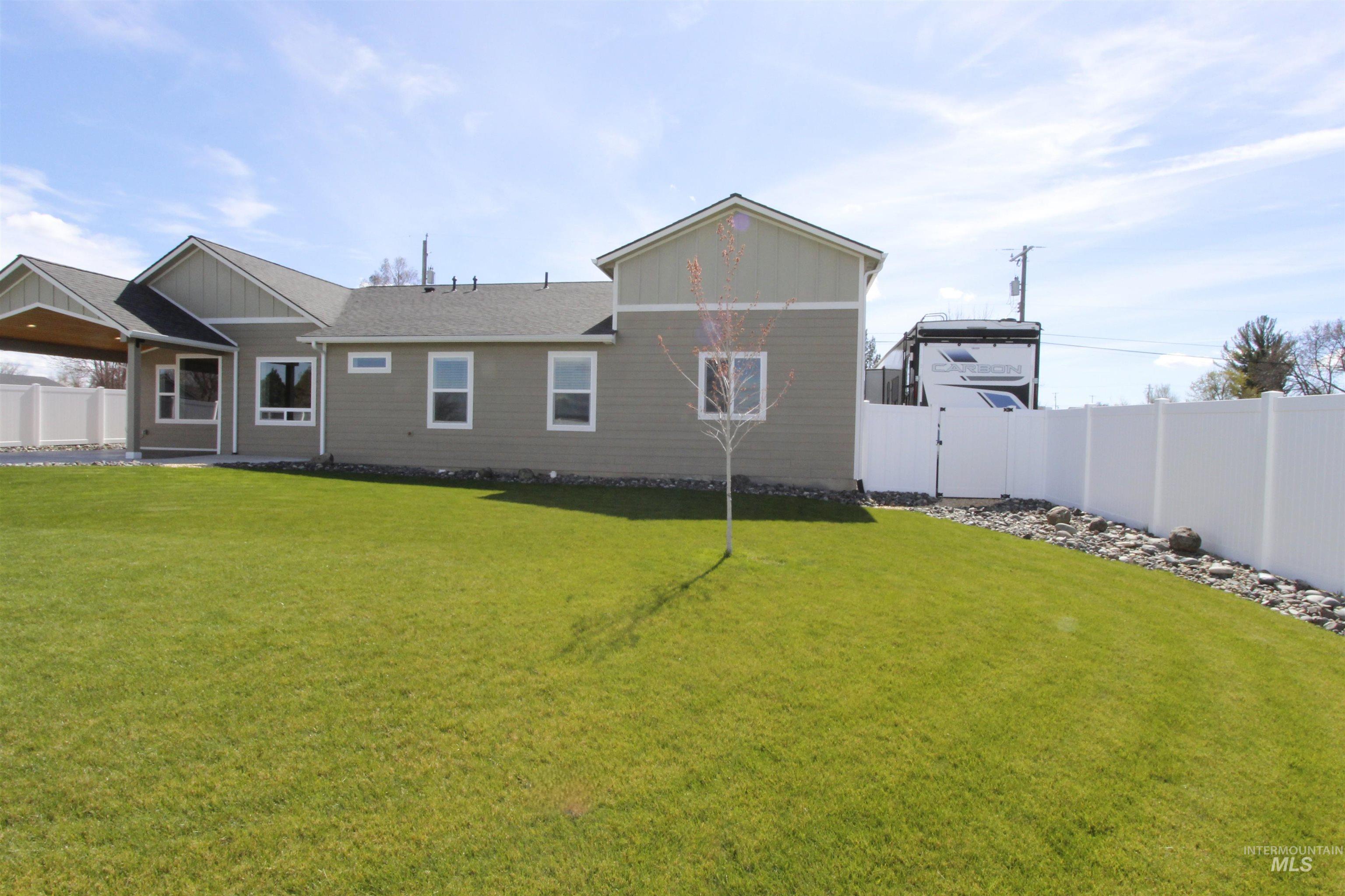 2013 Cedar Avenue Lewiston, ID 83501 - Photo 34 of 46 Rear view of house featuring a fenced backyard, a patio area, and a gate
