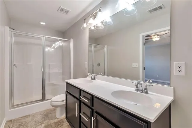 a bathroom with a sink double vanity and a mirror