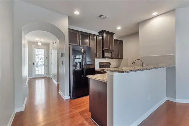 a kitchen with stainless steel appliances granite countertop a refrigerator and a sink