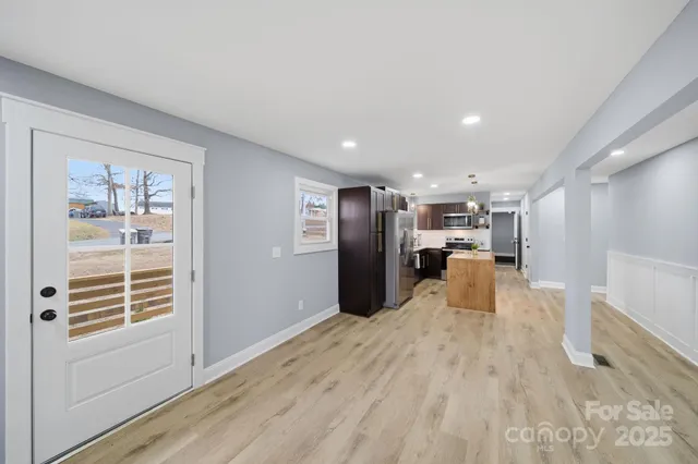 a view of kitchen with furniture and refrigerator