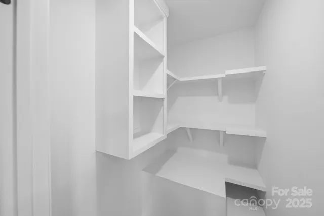 a view of an empty walk in closet