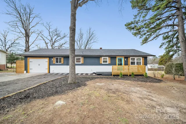 a view of a house with a yard covered in snow