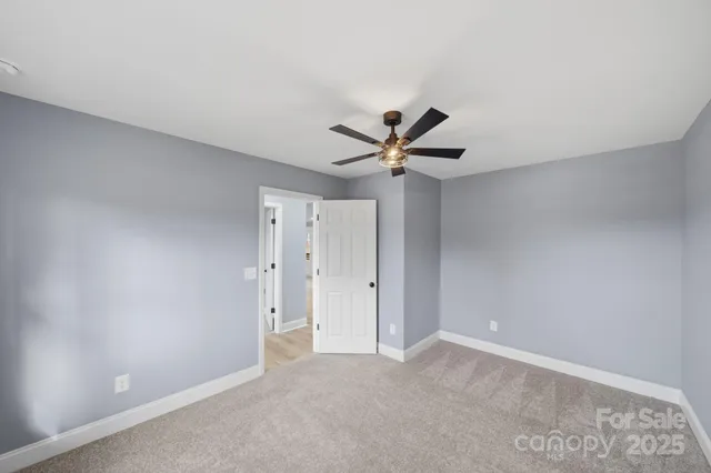 a view of a room with a ceiling fan and a window