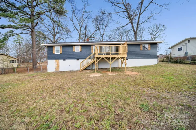 a view of a yard with a house and a tree