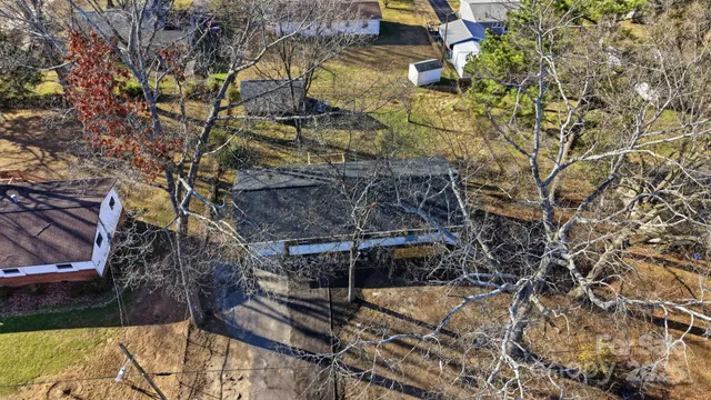 a wooden bench sitting in the middle of a yard