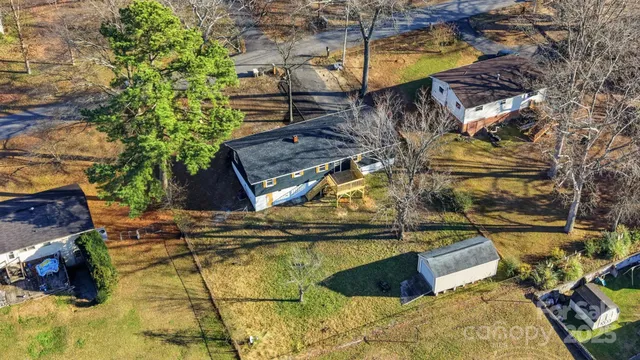 a roof deck with table and chairs and potted plants