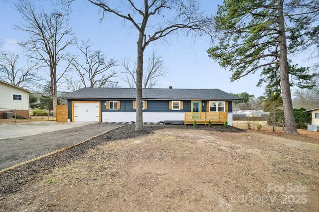 a view of a house with a yard covered in snow