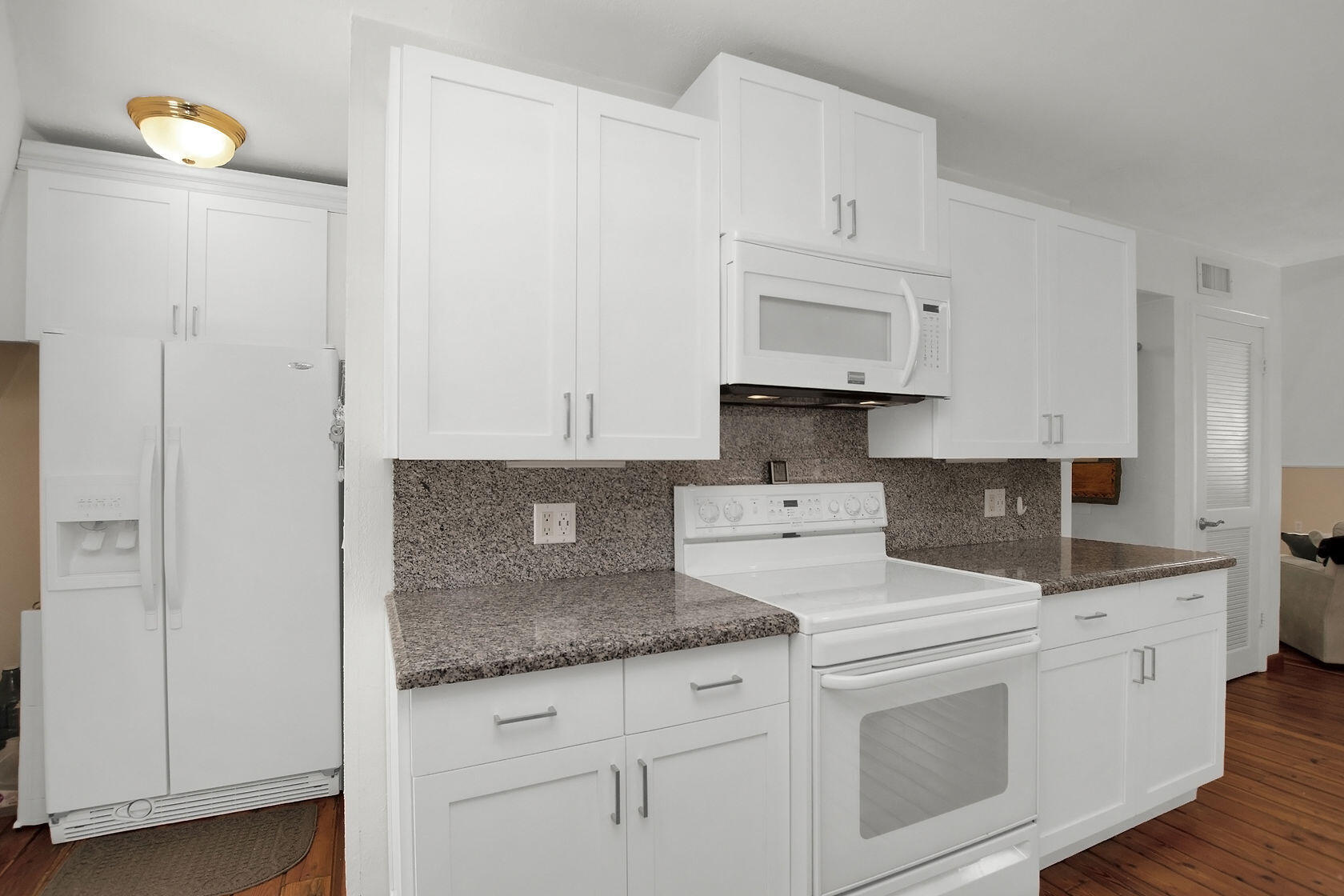 676 Sailfish Trail Key Largo, FL 33037 - Photo 12 of 38 a kitchen with granite countertop white cabinets and white appliances