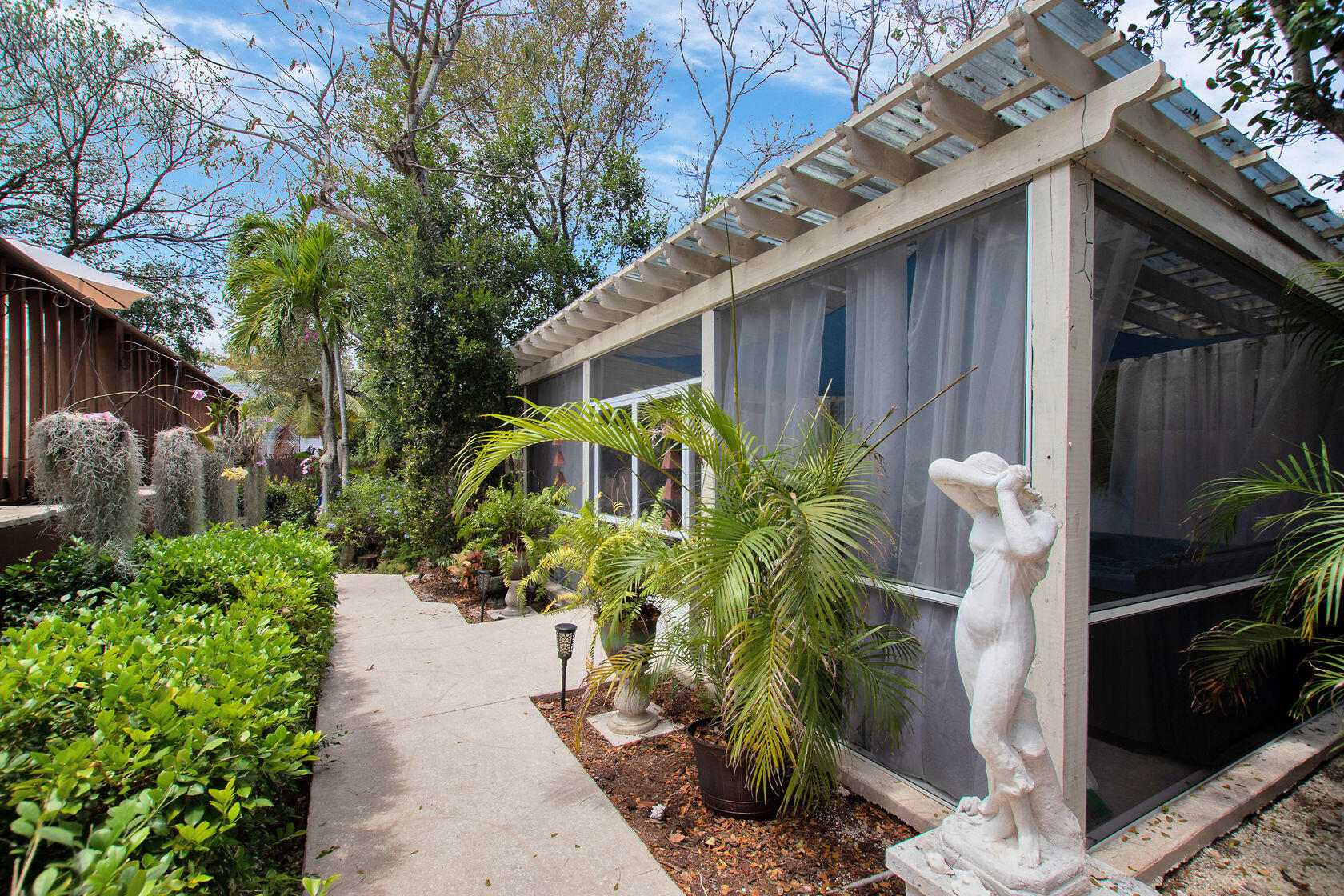 676 Sailfish Trail Key Largo, FL 33037 - Photo 26 of 38 a backyard of a house with a garden