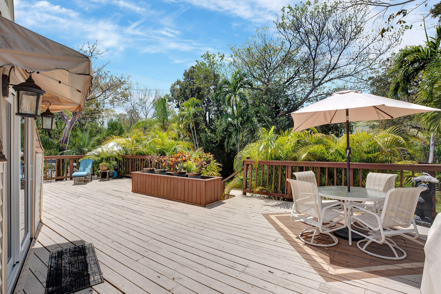 676 Sailfish Trail Key Largo, FL 33037 - Photo 3 of 38 a view of a tables and chairs under an umbrella