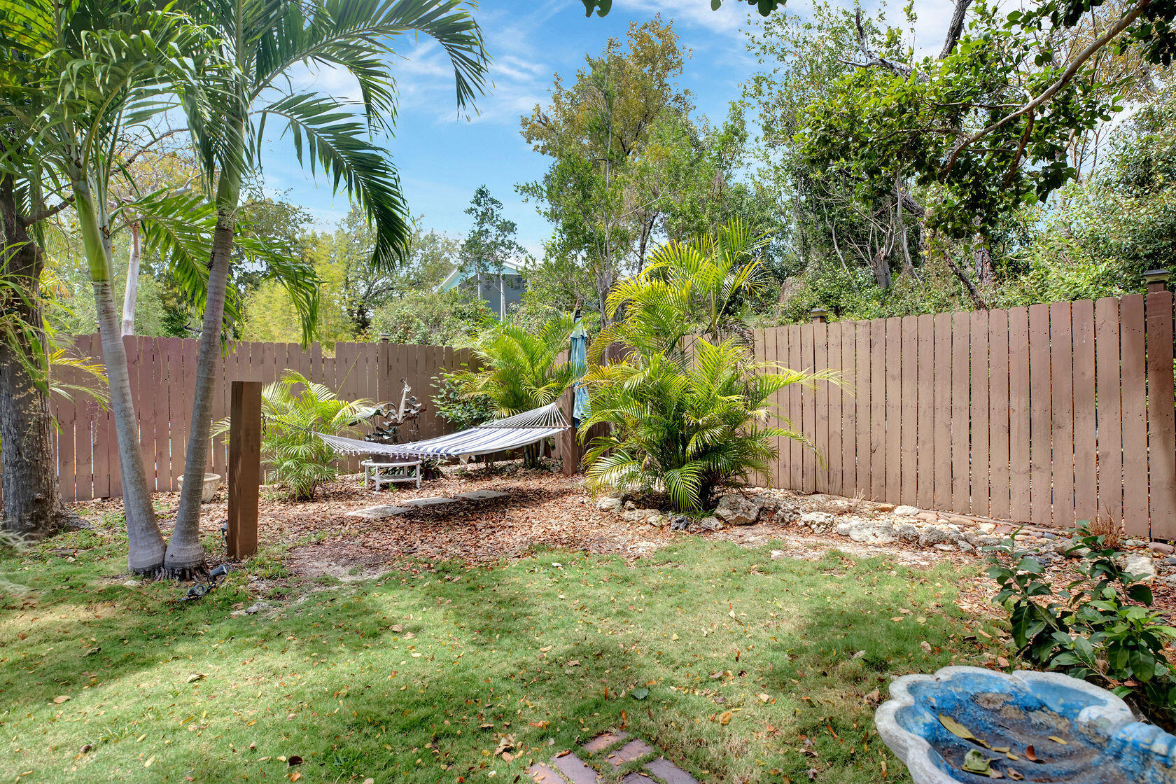 676 Sailfish Trail Key Largo, FL 33037 - Photo 33 of 38 a view of a backyard with potted plants and large trees