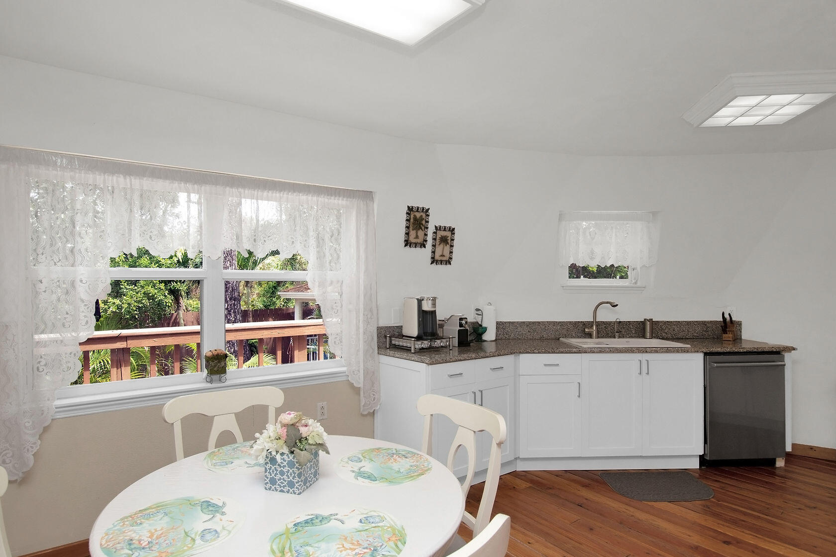 676 Sailfish Trail Key Largo, FL 33037 - Photo 10 of 38 a kitchen with stainless steel appliances kitchen island wooden floors and view of living room