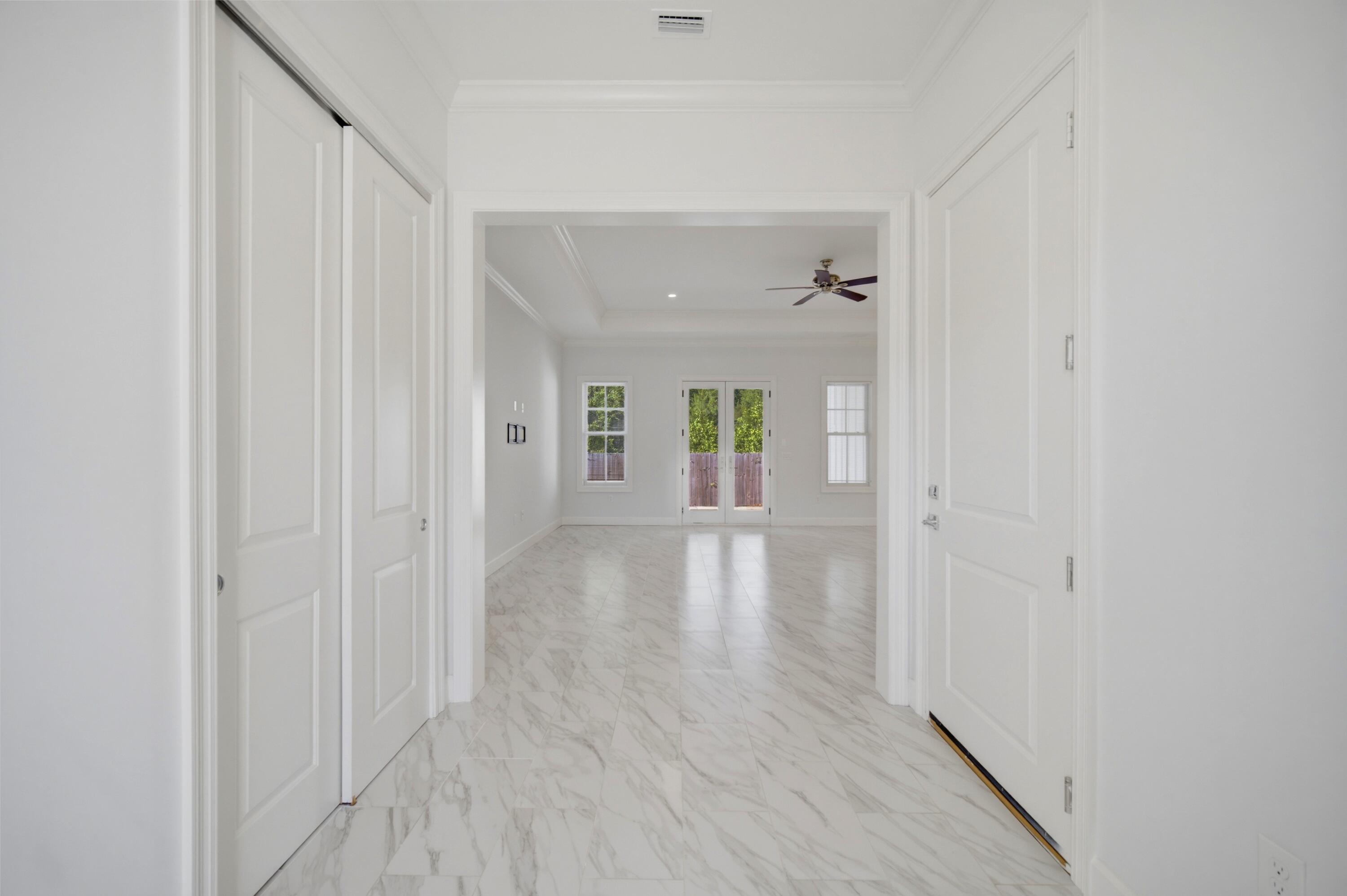 120 Lillian Way Crestview, FL 32536 - Photo 33 of 67 a view of a hallway with wooden floor and a bathroom